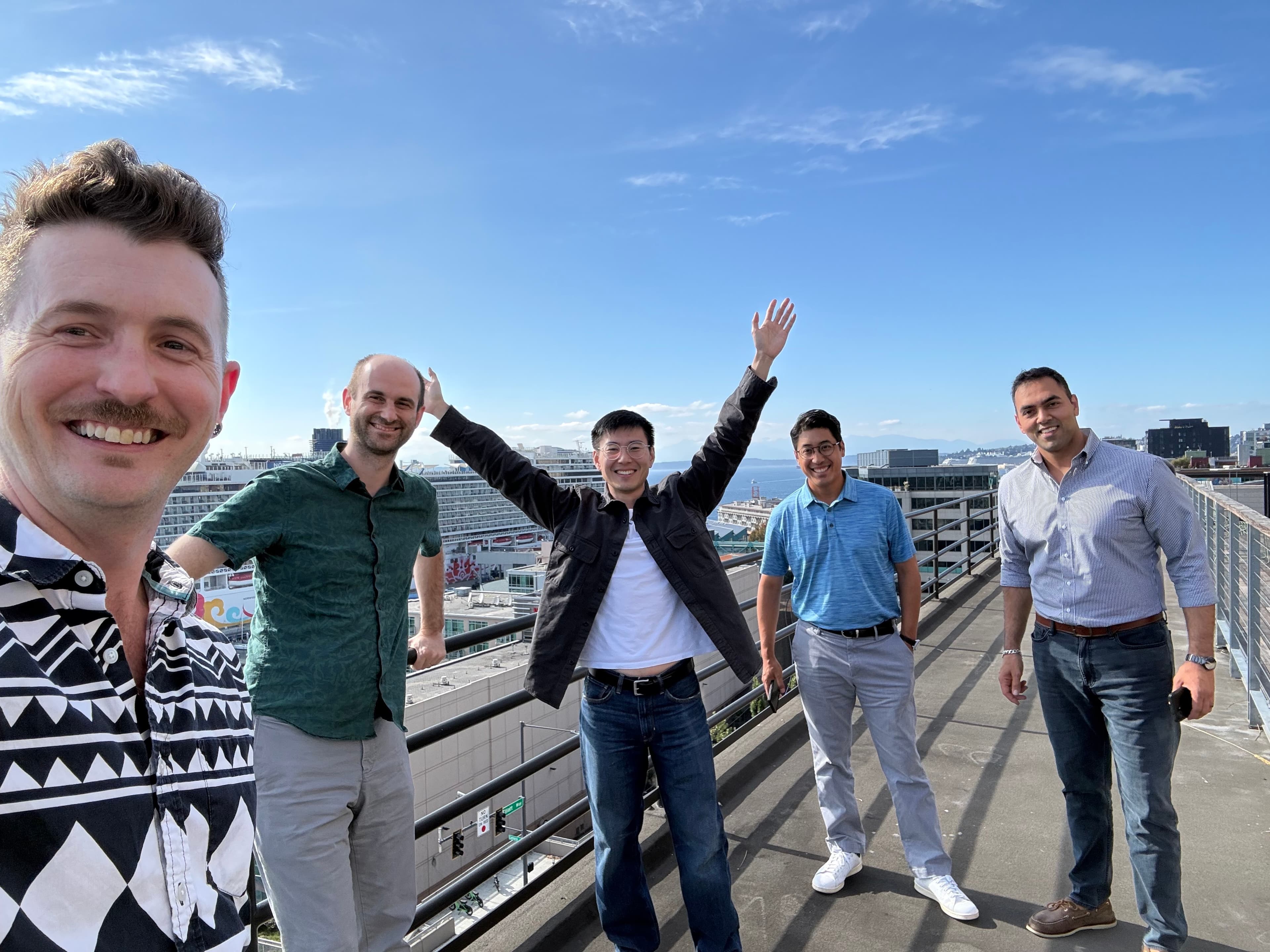 The Meadow team celebrating together on a rooftop overlooking the city