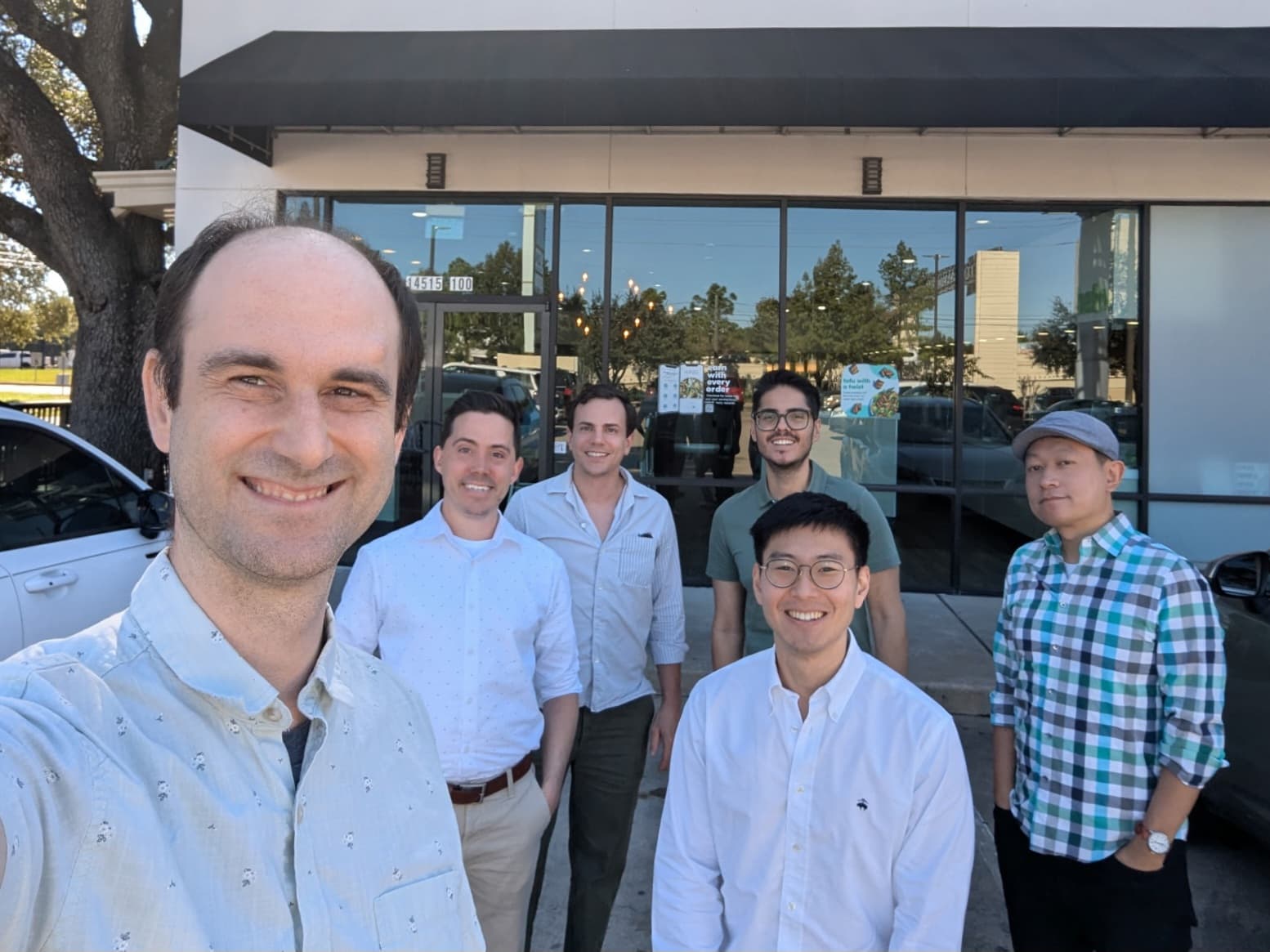 The Meadow team taking a group selfie outside a storefront